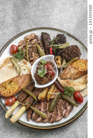 mixed grilled meat bbq gourmet big plate on restaurant table mixed grilled meat bbq gourmet big plate on restaurant table 141305480