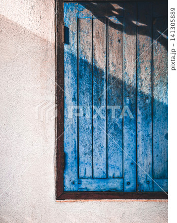 Vintage Blue Wooden Window on Rustic White Concrete Wall with Soft Shadow Vintage Blue Wooden Window on Rustic White Concrete Wall with Soft Shadow 141305889