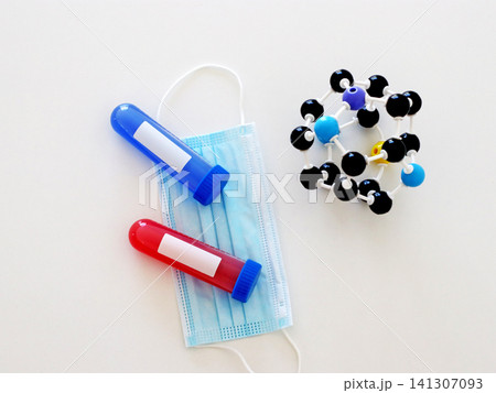 Medical composition with laboratory sample tubes, protective mask and molecular model for virus diagnostics and scientific analysis. Healthcare scene for infectious disease research concepts. Medical composition with laboratory sample tubes, protective mask and molecular model for virus diagnostics and scientific analysis. Healthcare scene for infectious disease research concepts. 141307093
