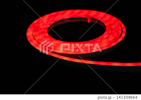 Red LED strip light glowing on black background, flexible neon style lighting 141309664