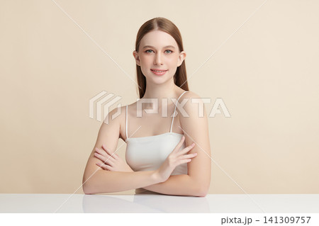 A beautiful young Asian woman with clean, fresh skin against a beige background. Skincare, facial treatment, cosmetology, beauty, and spa. An elegant portrait of an Asian woman. A beautiful young Asian woman with clean, fresh skin against a beige background. Skincare, facial treatment, cosmetology, beauty, and spa. An elegant portrait of an Asian woman. 141309757