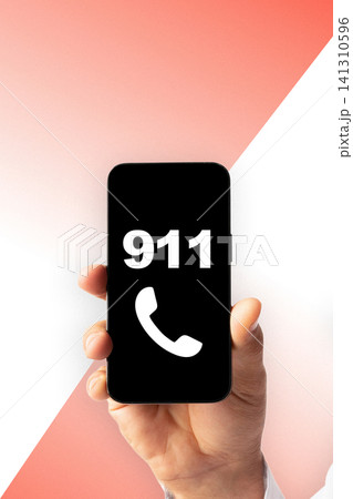 Emergency call to 911 displayed on a smartphone held by a person in a clear environment 141310596