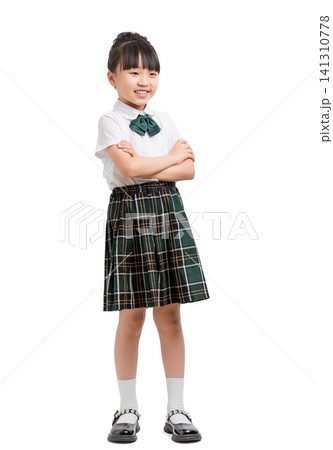Confident Asian schoolgirl with crossed arms standing isolated on white background, leadership and self confidence concept Confident Asian schoolgirl with crossed arms standing isolated on white background, leadership and self confidence concept 141310778