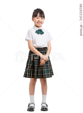 Full length portrait of a polite school girl standing with her hands clasped. Full length portrait of a polite school girl standing with her hands clasped. 141310780