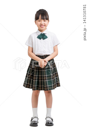 Full length portrait of a polite school girl standing with her hands clasped. Full length portrait of a polite school girl standing with her hands clasped. 141310781