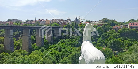 White deer statue overlooking Novoplanivskyi bridge in Kamianets-Podilskyi White deer statue overlooking Novoplanivskyi bridge in Kamianets-Podilskyi 141311448