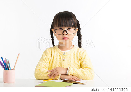 Asian schoolgirl showing various emotions while doing homework, feeling confused, inspired, and excited. Asian schoolgirl showing various emotions while doing homework, feeling confused, inspired, and excited. 141311593