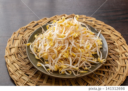 fresh crunchy bean sprouts on a ceramic plate, a classic topping ingredient for Chinese noodles. 141312698