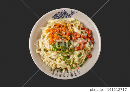 handmade flat wheat noodles with sesame paste and peanut toppings, authentic Chinese regional dish. 141312717