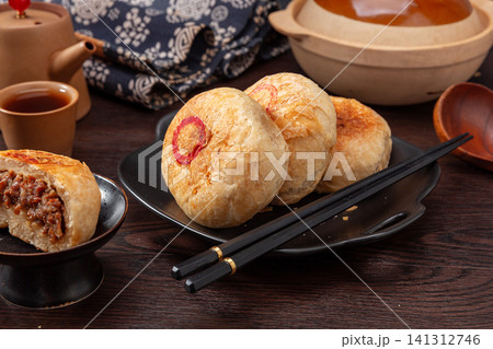 authentic Tianjin Shaobing, crispy baked sesame biscuits filled with seasoned beef. 141312746