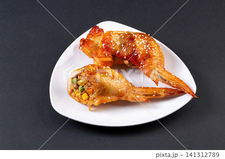 delicious grilled whole chicken wings stuffed with seasoned glutinous rice and vegetables delicious grilled whole chicken wings stuffed with seasoned glutinous rice and vegetables 141312789