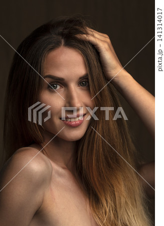 portrait of a young beautiful woman on a dark background portrait of a young beautiful woman on a dark background 141314017