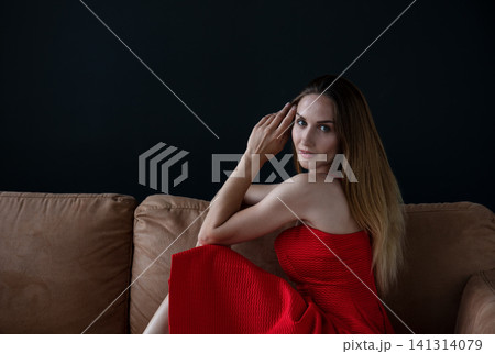 portrait of a young beautiful woman on a dark background portrait of a young beautiful woman on a dark background 141314079