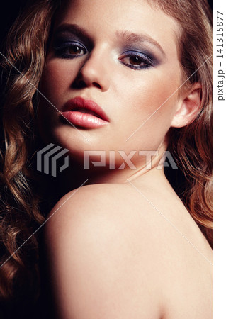 Portrait, woman and makeup on face in studio with bright eyeshadow, sensual lips and wavy hair for beauty. Confident, female person and cosmetics, skincare and self love for glowing healthy skin Portrait, woman and makeup on face in studio with bright eyeshadow, sensual lips and wavy hair for beauty. Confident, female person and cosmetics, skincare and self love for glowing healthy skin 141315877