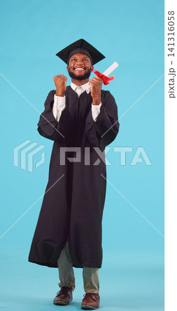 Black man, graduation and education achievement with celebration, excited and happy with diploma on blue background. Goal, future and certified with academic win, ceremony and cap with gown in studio 141316058