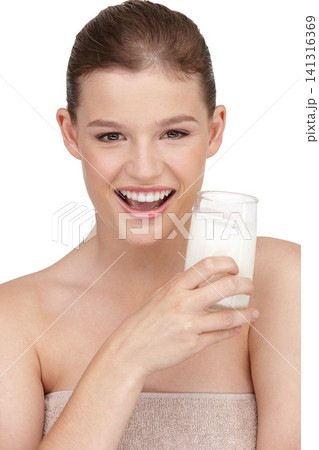 Portrait, female person and healthy diet by drinking milk in studio for calcium, nutrition and protein with detox benefits. Happy, woman and dairy product smoothie with natural vitamins for wellness 141316369