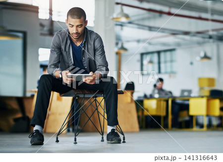 Business, graphic designer and man on chair, tablet and typing with connection, relax and website info. Person, creative agency and consultant with technology, network and social media in office 141316643
