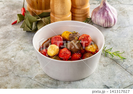 Colorful marinated meatballs in white bowl with garlic rosemary and spices 141317027