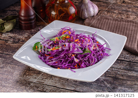 Vibrant purple cabbage salad with carrot and herbs on white plate Vibrant purple cabbage salad with carrot and herbs on white plate 141317125
