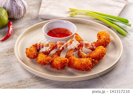 Crispy fried shrimp with spicy dipping sauce and fresh ingredients Crispy fried shrimp with spicy dipping sauce and fresh ingredients 141317210