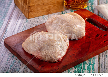 Raw chicken breasts on wooden cutting board Raw chicken breasts on wooden cutting board 141317249