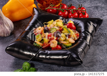 Shrimp and vegetable salad in black bowl with fresh ingredients Shrimp and vegetable salad in black bowl with fresh ingredients 141317275