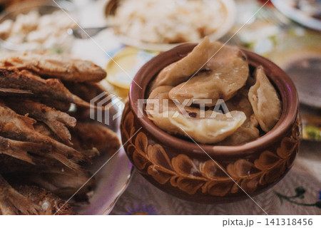 Dumplings with fried onions in a traditional Ukrainian plate. Dumplings with fried onions in a traditional Ukrainian plate. 141318456