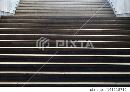 Underground passage or subway, steps of staircase lead upward to an exit, onto the surface of the earth with empty space. Symbolism of way out of crisis, transition from darkness to light side 141318712