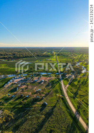 Aerial vertical scene showcasing the Pilliga Artesian Bore Baths and adjacent campground, surrounded by lush green bushland and peaceful rural scenery near Pilliga, NSW, Australia. 141319234