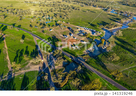 Aerial view showcasing the Pilliga Artesian Bore Baths and adjacent campground, with a winding creek flowing through the lush green landscape, highlighting the peaceful bushland setting near Pilliga, Aerial view showcasing the Pilliga Artesian Bore Baths and adjacent campground, with a winding creek flowing through the lush green landscape, highlighting the peaceful bushland setting near Pilliga, 141319246