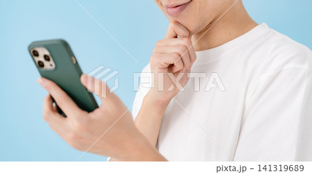 真剣にスマホを見る男性 手元 真剣にスマホを見る男性 手元 141319689