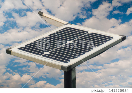 Solar panels against white clouds in the blue sky - close up Solar panels against white clouds in the blue sky - close up 141320984