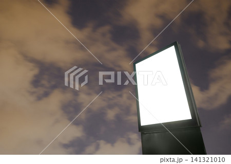 White billboard poster, pillar against warm clouds at night - mock up 141321010