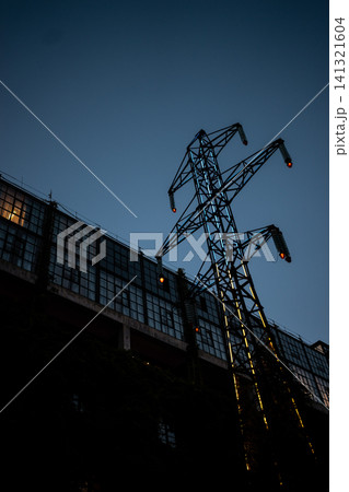 abandoned high voltage power supply line pylon with damaged wires 141321604