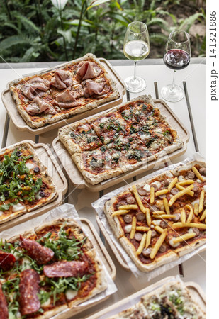 many different Pinsa types on garden restaurant pizza slice buffet table outdoors many different Pinsa types on garden restaurant pizza slice buffet table outdoors 141321886