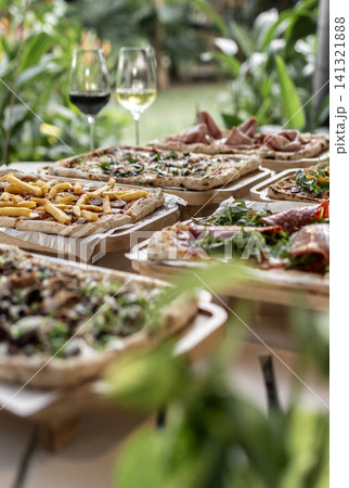 many different Pinsa types on garden restaurant pizza slice buffet table outdoors many different Pinsa types on garden restaurant pizza slice buffet table outdoors 141321888