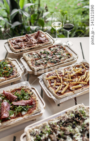 many different Pinsa types on garden restaurant pizza slice buffet table outdoors many different Pinsa types on garden restaurant pizza slice buffet table outdoors 141321890