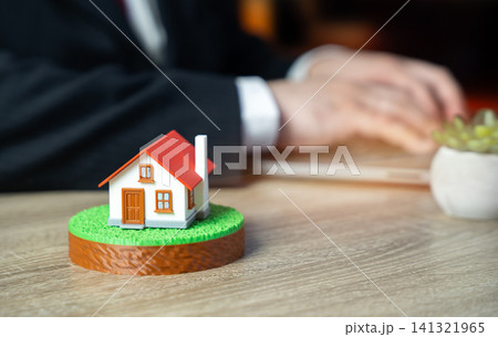 House on land showing Real estate construction. Buying and selling property. Development planning, investment, housing projects drive market growth and ownership opportunities. 141321965