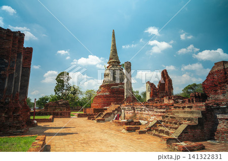 Ancient headless Buddha statues lining the red brick wall at Wat Mahathat in Ayutthaya, Thailand. 141322831