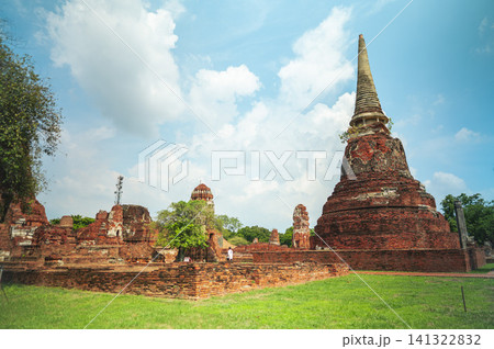 Ancient headless Buddha statues lining the red brick wall at Wat Mahathat in Ayutthaya, Thailand. Ancient headless Buddha statues lining the red brick wall at Wat Mahathat in Ayutthaya, Thailand. 141322832