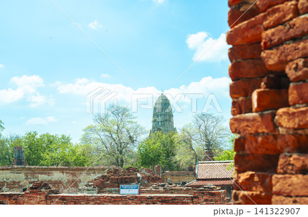 Ancient headless Buddha statues lining the red brick wall at Wat Mahathat in Ayutthaya, Thailand. 141322907