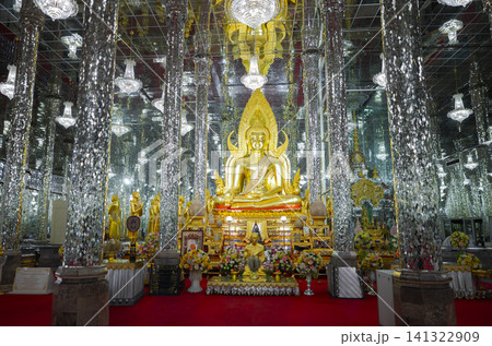 Golden Buddha sculpture sitting in spectacular mirror hall with silver glass pillars, Thailand landmark. 141322909