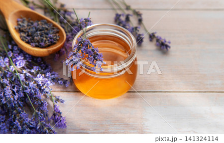 Lavender honey jar with fresh herbs and dried flowers 141324114