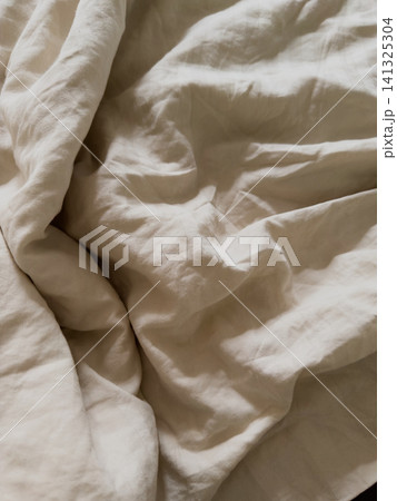 Rumpled cream duvet cover texture with soft folds, extreme close up Rumpled cream duvet cover texture with soft folds, extreme close up 141325304