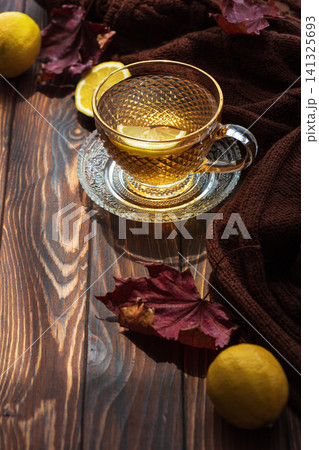 Warm lemon tea preparing for an autumn day Warm lemon tea preparing for an autumn day 141325693