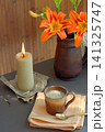 Orange lilies, apricots and a cup of coffee with milk foam on the table 141325747
