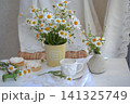 Cappuccino in a white cup with cakes and daisies 141325749
