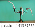 A hot summer concept. A candelabra with candles that melt in the heat. 141325752