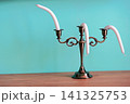 A hot summer concept. A candelabra with candles that melt in the heat. 141325753