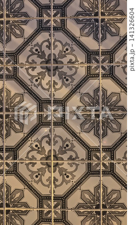 Decorative ceramic tiles featuring intricate geometric patterns in black and white, arranged in a symmetrical layout on a surface Decorative ceramic tiles featuring intricate geometric patterns in black and white, arranged in a symmetrical layout on a surface 141326604